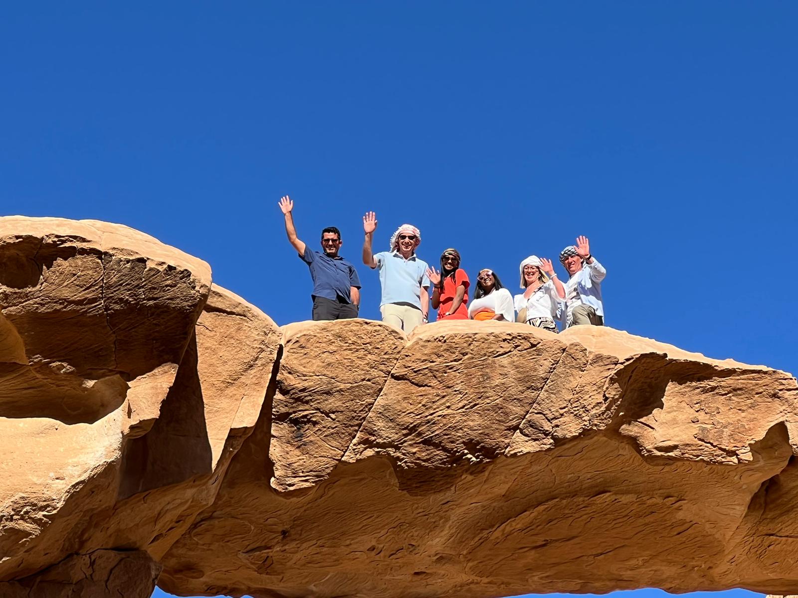 Travellers, hands up on the dune